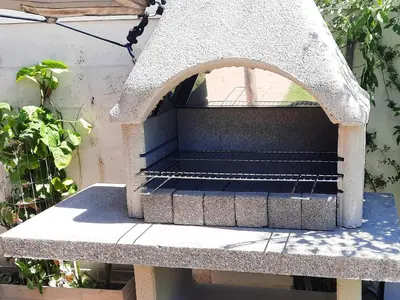 a stone bench sitting next to a building at Wilcre's blouberg home in Cape Town
