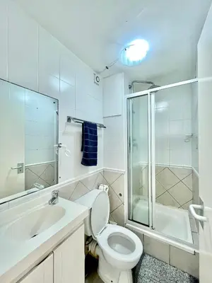 a bathroom with a toilet and a sink and a shower at Ocean View Apartment in Cape Town