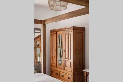 a bedroom with a wooden cabinet in a room at De Goede Hoop Farmstead in Wilgerhof