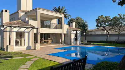 a house with a swimming pool in the yard at The CoziPlace in Cape Town
