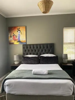 a large bed in a bedroom with a large bedvisor at The CoziPlace in Cape Town