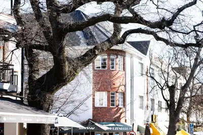 a large brick building with a tree in front of it at Avemore Jan Cats No 3 full back up power in Stellenbosch