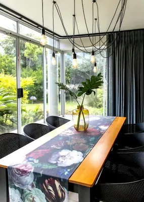 a dining room with a table with a plant on it at Milas Place Spacious & Comfortable at Bayview in Hermanus