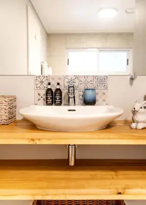 a bathroom with a sink on a wooden counter at Milas Place Spacious & Comfortable at Bayview in Hermanus