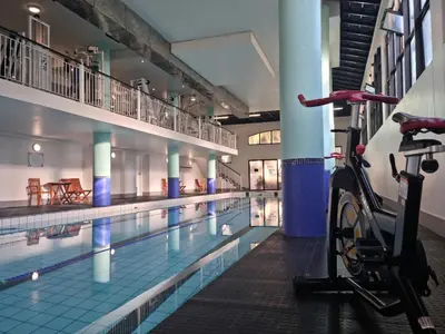 a swimming pool with a bike parked next to it at Island Club by Smart City Stays in Cape Town