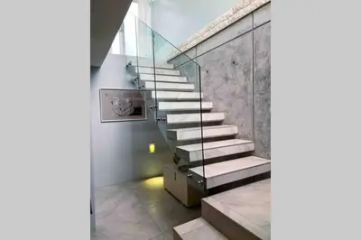 a staircase in a room with a glass wall at Beach & Mountain Retreat within a UNESCO Biosphere in Rooiels