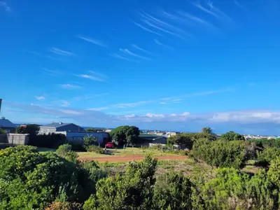 a view of a park with trees and a blue sky at Cottage Amnesia in Bettyʼs Bay