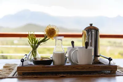 a table with a tray with cups and a jug of milk at Fynbosrust in Wolseley