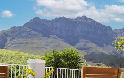 a view of a mountain from a balcony with mountains at House on Charme in Stellenbosch