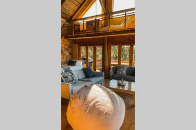 a living room with a couch and a table at Stonewood Mountain Cabin in Breerivier