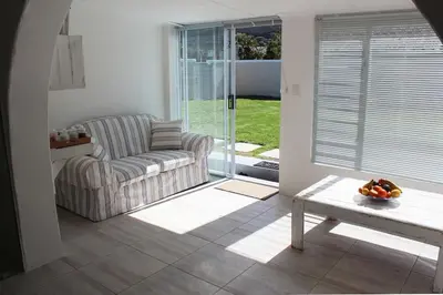 a living room with a couch and a table at 57 on Vermont in Hermanus