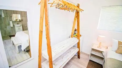 a wooden swing in a room with a mirror at 57 on Vermont in Hermanus