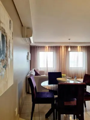 a dining room and living room with a table and chairs at Manhattan by Smart City Stays in Cape Town