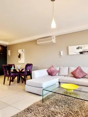 a living room with a couch and a table at Manhattan by Smart City Stays in Cape Town