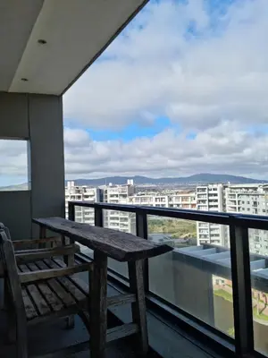 a wooden bench sitting on top of a balcony at Manhattan by Smart City Stays in Cape Town