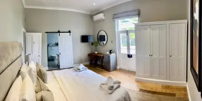 a bedroom with a large bed in a room at Sunset Farm Stellenbosch in Stellenbosch