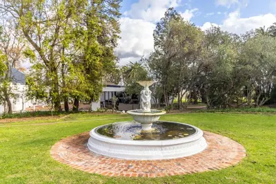 a fountain in the middle of a yard at Sunset Farm Stellenbosch in Stellenbosch