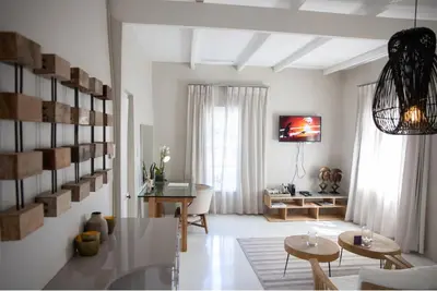 a white living room with a table and chairs at Macaron Boutique Guest House in Franschhoek