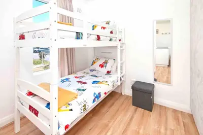 a white bunk bed in a small room with a bunk bedutenewayangering at Luxury @ the Ocean in Hermanus