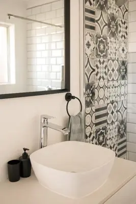 a bathroom with a white sink and a shower at Luxury @ the Ocean in Hermanus