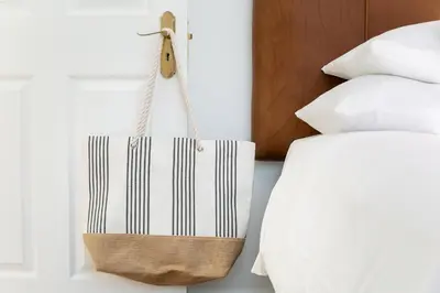 a tote bag hanging next to a bed at La Maison On Main Self-Catering Villa in Paarl