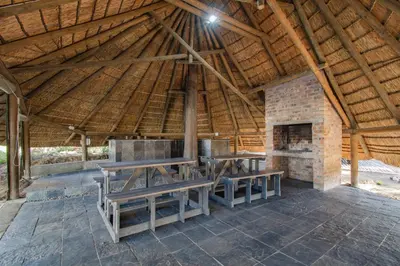a wooden pavilion with picnic tables and a fireplace at the MANOR house by Kana Guest Farm - Ideal for groups in Stellenbosch