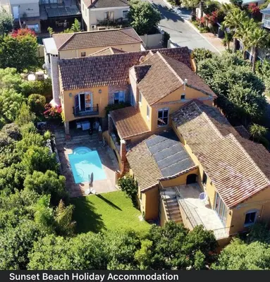 an aerial view of a house with a swimming pool at Sunset Beach holiday accommodation in Cape Town