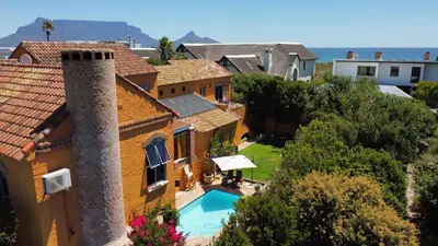 an aerial view of a house with a swimming pool at Sunset Beach holiday accommodation in Cape Town