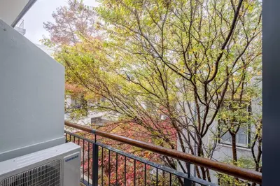 a balcony with a view of trees and buildings at Lemon Rind - 16 Eikehoff in Stellenbosch