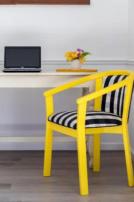 a yellow desk with a yellow chair and a laptop at Birdsong in Hermanus