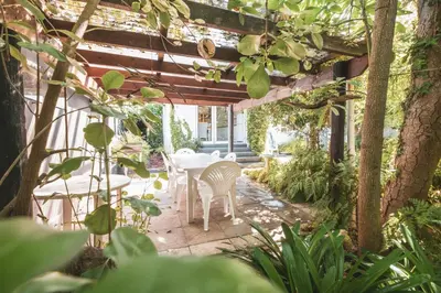 a patio with a table and chairs under a pergola at Birdsong in Hermanus