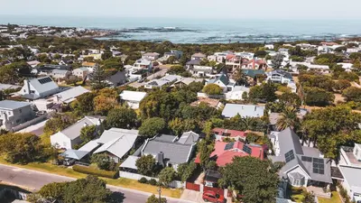 an aerial view of a residential neighborhood with the ocean at Birdsong in Hermanus