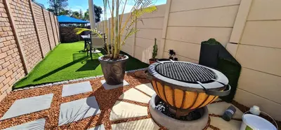 a patio with a grill with a plant in it at Walters Lane Comfort Apartment 2 - No Loadshedding in Cape Town