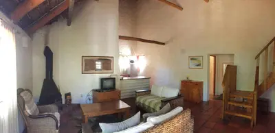 a living room with a couch and a tv and a table at Mooi Bly in Paarl