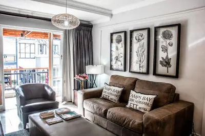 a living room with a couch and a chair at Avemore Jan Cats No 5 full backup power in Stellenbosch