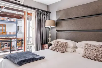 a bedroom with a large bed and a window at Avemore Jan Cats No 5 full backup power in Stellenbosch