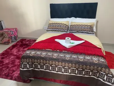 a bed with a tray with a napkin and a candle on it at SABATH LODGE in Cape Town