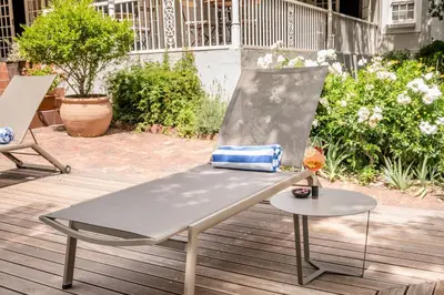 a bench on a deck with a purse on it at Corner House Residence in Franschhoek