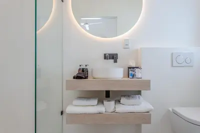 a bathroom with a sink and a mirror at Droom Guesthouse in Franschhoek