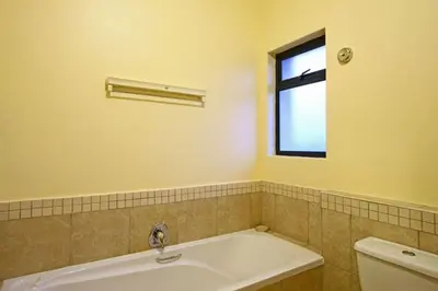 a bathroom with a bath tub and a window at Knightsbridge 407 by Host Agents in Cape Town