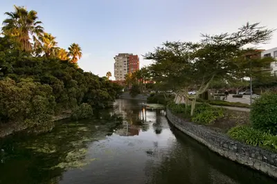 a river in a city with trees and a building at Knightsbridge 407 by Host Agents in Cape Town