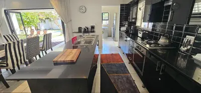 a kitchen with a black counter top and a stove at Villa Parisienne Modern Guest house in Cape Town