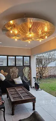 a living room with a couch and a ceiling at Villa Parisienne Modern Guest house in Cape Town
