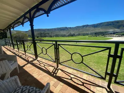 a view from the porch of a golf course at 19th Hole Guest Lodge - Golfers paradise in Hermanus