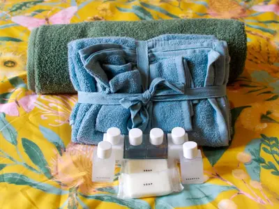 a pile of towels and four bottles on a blanket at Proleefic House on Florence in Bellville