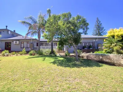 a house with a yard in front of it at Glennies Guesthouse in Somerset West