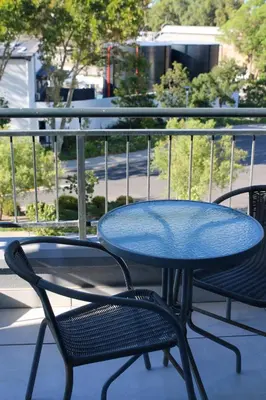 a blue table and two chairs on a balcony at The Jade Somerset West in Cape Town
