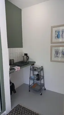 a kitchen with a counter and a shelf in a room at Yellow Door Hermanus in Hermanus