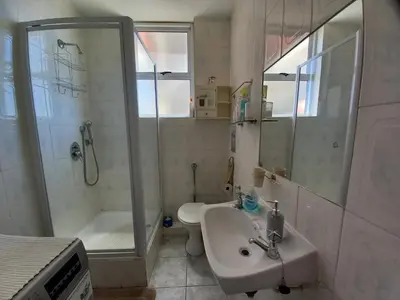 a bathroom with a sink and a shower and a toilet at St Tropez 301 in Strand