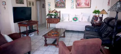 a living room with a couch and a tv at St Tropez 301 in Strand